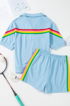 Light blue activewear set with rainbow stripe detail on shirt and shorts.