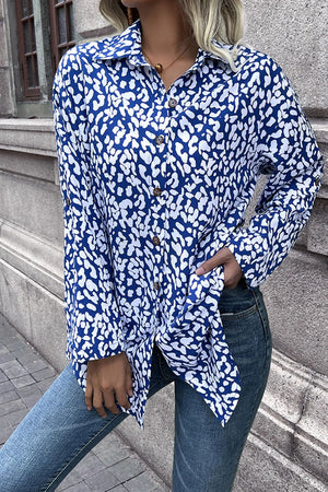 Sky blue oversized shirt with abstract spot print, buttoned front, and collar.