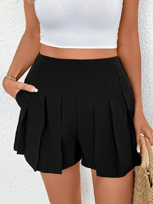 Black pleated shorts with pockets, featuring a textured fabric and a high-waisted fit.