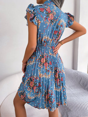 Turquoise floral mini dress with pleated skirt and ruffle sleeves.
