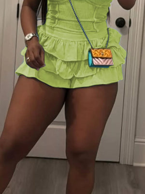 Grass green scoop neck cami with ruffled skirt ensemble, featuring a tiered ruffled hem and a small crossbody bag.