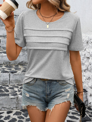 Light gray jersey top with pleated bodice detail and short sleeves.