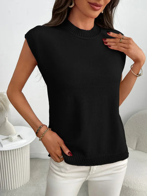 Black ribbed knit sleeveless mock neck top with gold bracelets.