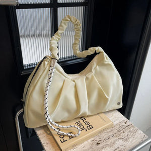 Ivory ruched handle crescent shoulder bag with rope strap detail.
