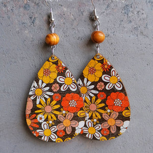 Teardrop earrings with wood bead and retro floral print in orange, yellow, and white.