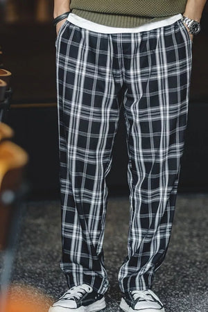 Relaxed fit black plaid men's sweatpants with a drawstring waist.
