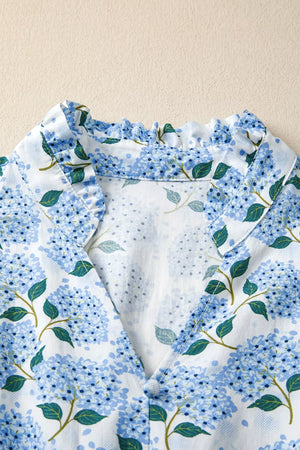 White cotton blend midi dress with blue hydrangea print, V-neck, and ruffled collar.