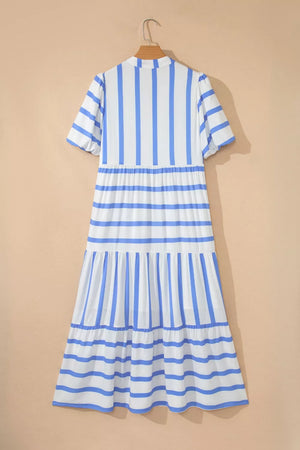 Tiered white and blue striped midi dress with short sleeves and ruffled hem.