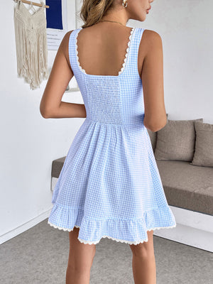 Sky blue gingham mini dress with smocked bodice and lace trim.