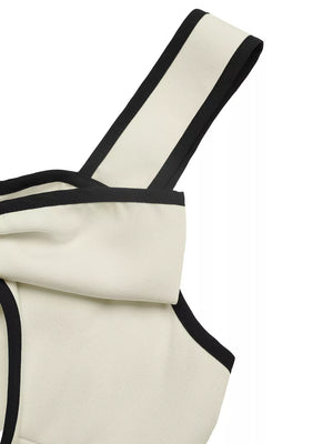 Beige A-line midi dress with black trim and bow detail on strap.