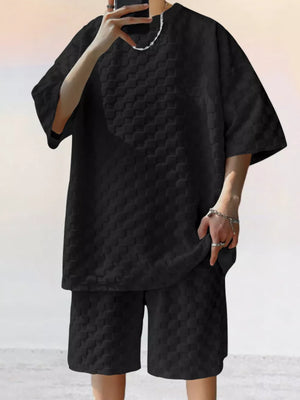 Black textured casual two-piece set for men with short sleeves and shorts.