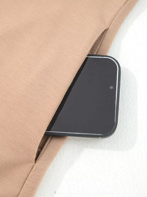 Braided Puff Sleeve Dress in Khaki with a phone in the side pocket.