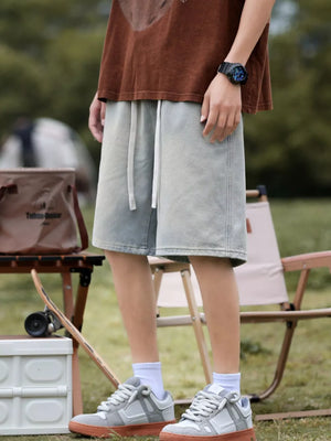 Light blue denim shorts with drawstring waist and relaxed fit.