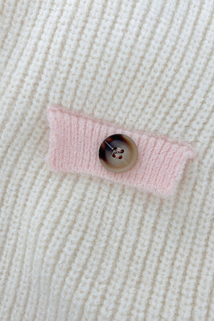 Cream knit cardigan with pink trim detail and button closure.