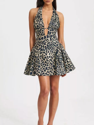 Leopard print halter neck mini dress with plunging neckline and flared skirt.