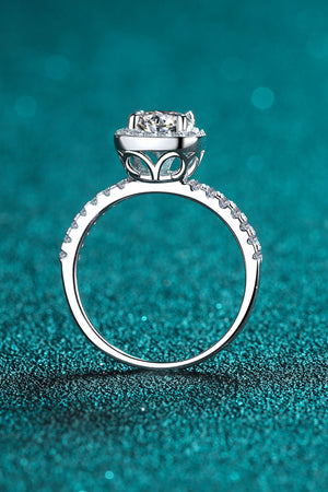 Silver cushion halo engagement ring with pavé band and intricate gallery detail.