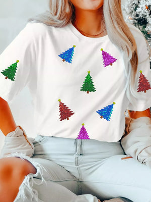 White t-shirt with scattered sequin Christmas trees in red, blue, green, and purple.
