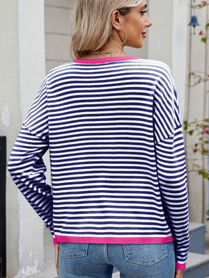 Navy and white striped knit sweater with fuchsia pink trim and drop shoulders.