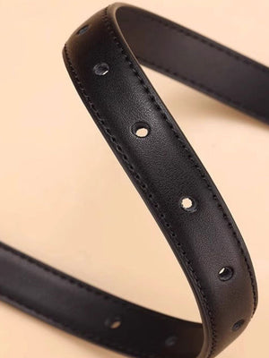Black cowhide leather belt with silver buckle detail and multiple holes.