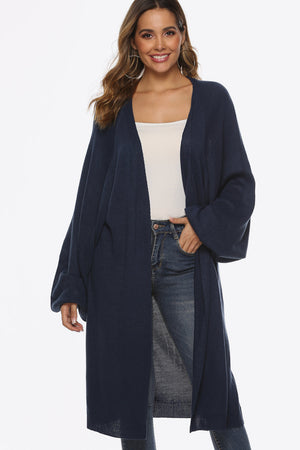 Dark blue oversized sleeve maxi knit cardigan with an open front and ribbed cuffs.