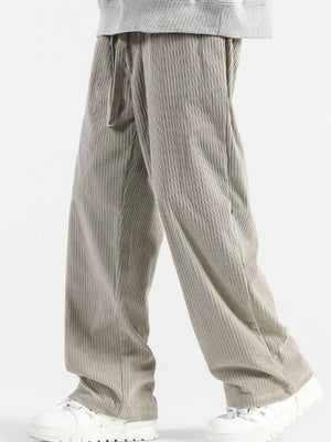 Men's gray wide-leg sweatpants with vertical texture and drawstring waist.