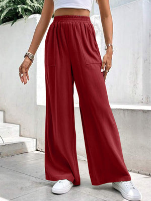 Burgundy relaxed drape palazzo trousers with pockets and elastic waist.