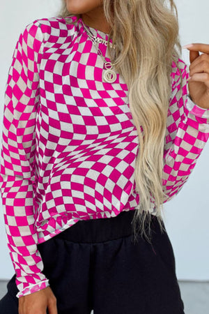 Optical illusion checkered mesh blouse in hot pink and white with long sleeves.