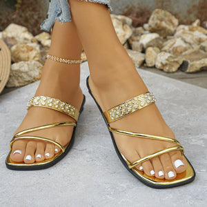 Gold rhinestone-studded square toe slide sandals with double straps.