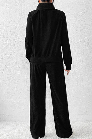 Black corduroy turtleneck lounge set with wide-leg pants and a relaxed fit jacket.