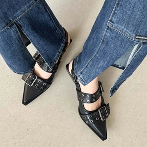 Black studded pointed-toe slingback flats with buckle straps