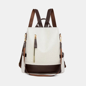 Ivory faux leather convertible backpack with brown trim and straps, featuring a textured finish.