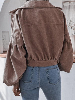 Brown corduroy cropped jacket with balloon sleeves and button-up front.
