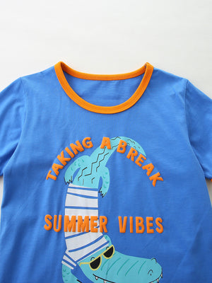 Blue cotton t-shirt with orange trim, featuring a playful crocodile graphic and text.