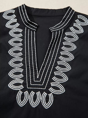 Black maternity overshirt with white embroidery detail on neckline and V-neck.