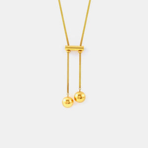 Gold lariat necklace with sphere drops and a bar detail