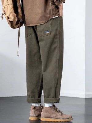 Plus-size army green cotton wide-leg trousers with embroidered pocket detail.