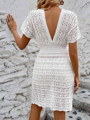 White openwork knit beach mini dress with V-neck and short sleeves.