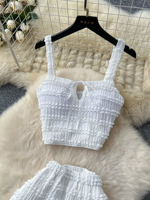 White ruched crop top with tie detail and matching mini skirt.