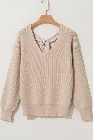 Beige ribbed knit sweater with V-neck and back bow detail