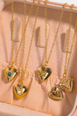 Gold heart locket necklaces with gemstone and pearl details on delicate chains