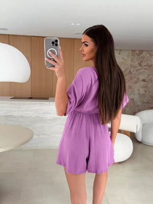 Heliotrope purple cinched waist romper with dolman sleeves and V-neck detail.