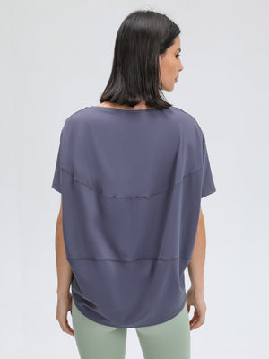Relaxed fit performance tee in Dusty Blue with short sleeves and a curved hem.