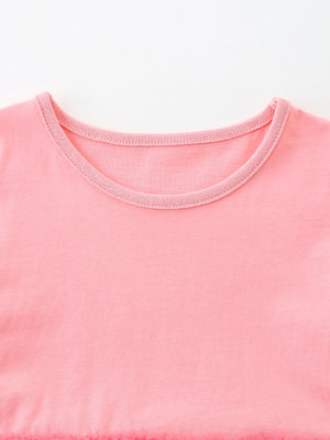 Pink cotton baby dress with a round neckline and ruffled hem detail.