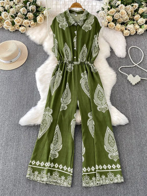 Green wide leg romper with white paisley print, collared, button-down, sleeveless, elastic waist