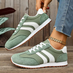 Green suede lace-up sneakers with white stripes and gum soles.