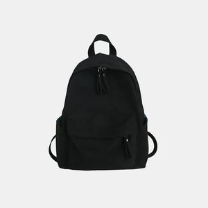 Black canvas school backpack with dual front pockets and zipper closures.