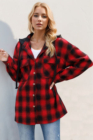Oversized red and black plaid hooded shirt jacket with button front and chest pockets.