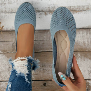 Sky blue breathable knit ballet flats with a quilted insole and a woman's hand wearing a turquoise ring.
