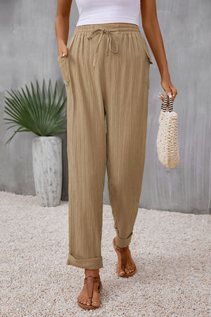 Khaki textured trousers with drawstring waist and cuffed hems
