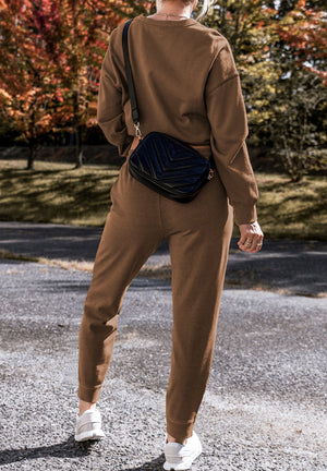 Relaxed fit lounge set in coffee brown, featuring a crewneck sweatshirt and jogger pants with side slits.